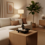 Buddha Ornament on a wooden coffee table with an incense holder and a plant in a modern living room