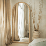 Elegant The Bali Concept Mirror with an arched wooden frame for a stylish home interior