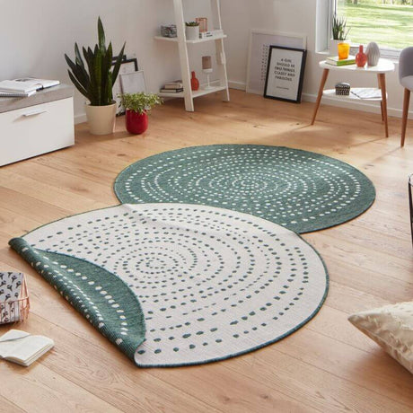 Stylish round rug in green and white, featuring a modern dot pattern, ideal for contemporary living spaces