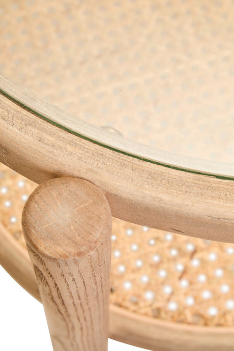 Orsina side table featuring a round glass top and a natural wood base with decorative cane pattern