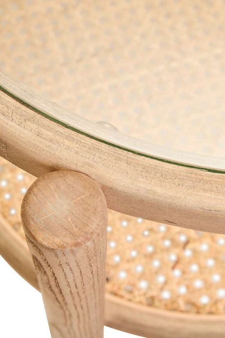 Orsina side table featuring a round glass top and a natural wood base with decorative cane pattern