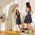 Elegant Standing Mirror in a bright room reflecting a woman in a polka dot dress
