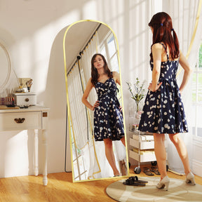 Elegant Standing Mirror in a bright room reflecting a woman in a polka dot dress