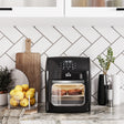 Wise Galleria Air Fryer in black showcasing evenly cooked snacks on a kitchen counter