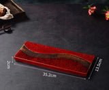Elegant red Ichi Dishes platter with unique wave design, ideal for serving sushi or snacks