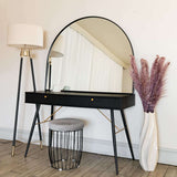 Arched Mirror above stylish black dressing table with modern lamp and decorative vase