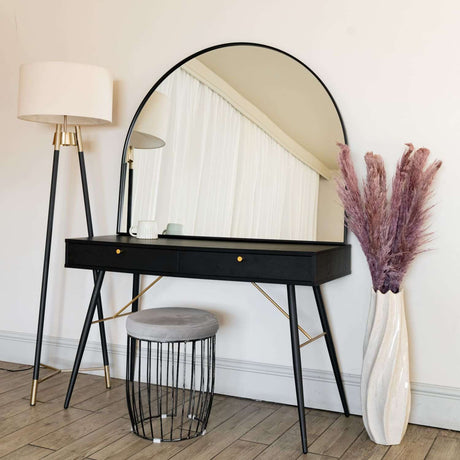 Arched Mirror above stylish black dressing table with modern lamp and decorative vase