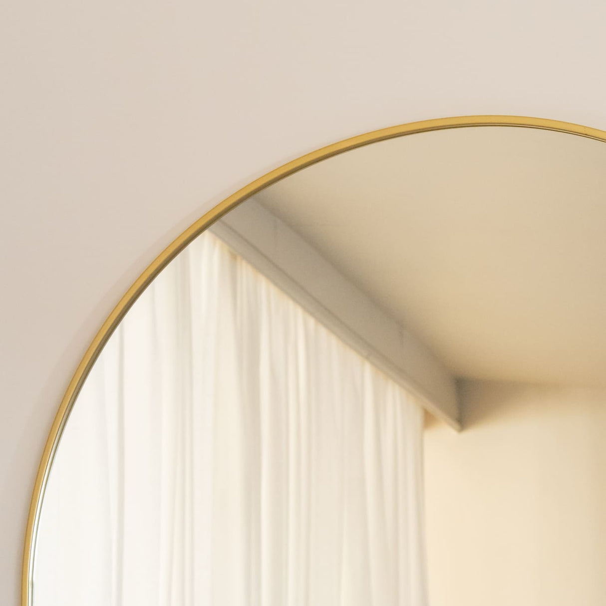 Jobu Home Arched Mirror with a sleek gold frame, perfect for enhancing any room's decor