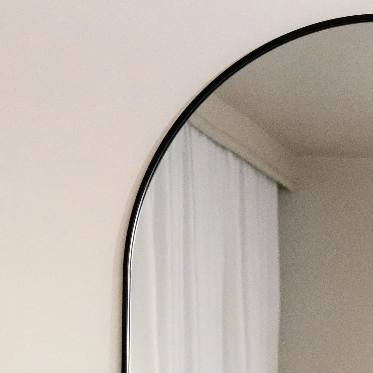 Elegant Jobu Home Oval Mirror with a sleek black frame for modern decor