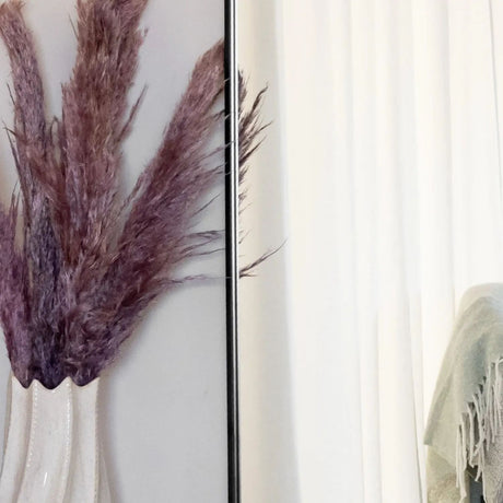 Jobu Home Oval Mirror with Elegant Black Frame and Decorative Faux Pampas Grass