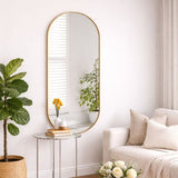 Stylish Jobu Home Oval Mirror with a sleek gold frame placed in a modern living room setting