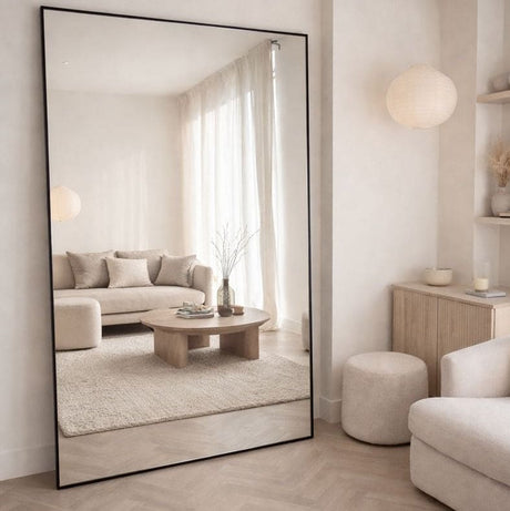 Large Rectangle Mirror by Jobu Home reflecting a stylish, modern living room interior