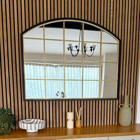 Jobu Home Window Mirror with an Arched Design and Gold Framed Grid on a Wooden Wall