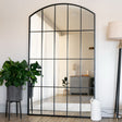 Jobu Home Window Mirror with an arched top and black frame, perfect for modern interiors