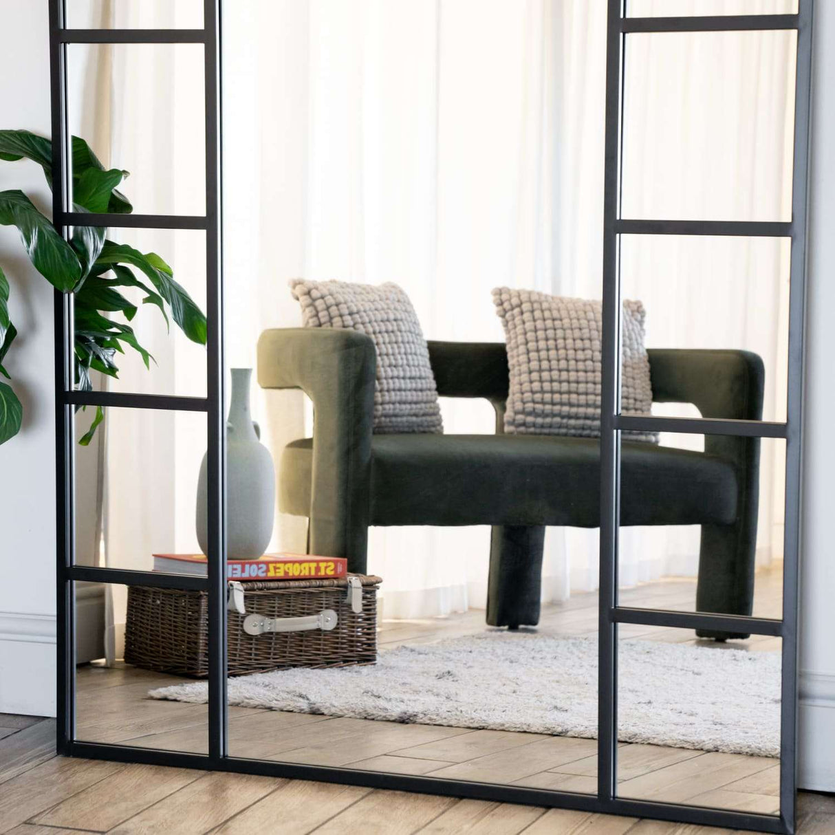 Stylish Jobu Home Window Mirror with Black Frame Reflecting a Modern Living Space