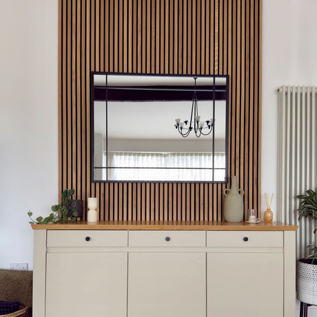 Jobu Home Window Mirror in a modern setting above a wooden console cabinet with plants