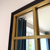 Jobu Home Window Mirror with a decorative gold frame, reflecting natural light in a stylish room