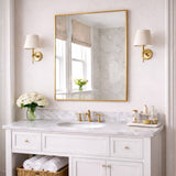 Elegant Rectangle Mirror with a Gold Frame Above a Marble Vanity in a Stylish Bathroom