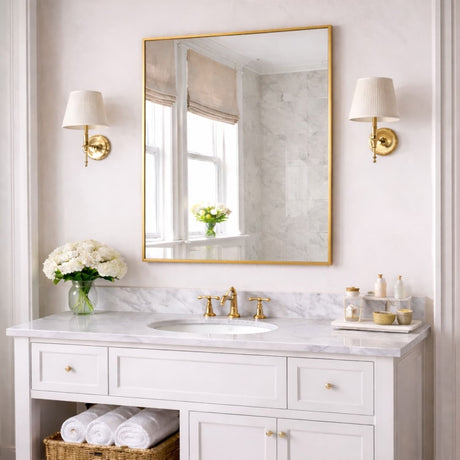 Elegant Rectangle Mirror with a Gold Frame Above a Marble Vanity in a Stylish Bathroom