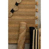Orsina Jute Rug featuring a textured design with tassels and rolled-up striped patterns