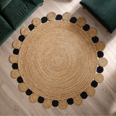 Orsina Jute Rug with a circular shape and decorative black pom-poms for stylish home decor