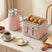 Wise Galleria Kettle and Toaster Set in Pink on a Kitchen Table with Coffee and Toast
