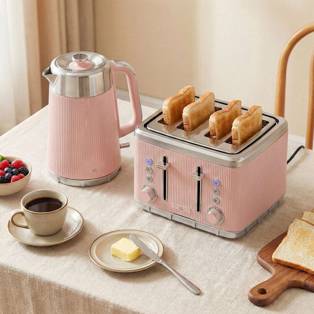 Wise Galleria Kettle and Toaster Set in Pink on a Kitchen Table with Coffee and Toast