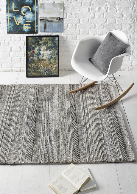 Stylish knitted rug in grey tones, perfect for enhancing modern living spaces
