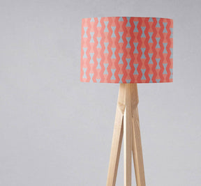 Shadow Bright patterned lampshade in coral and blue on a wooden tripod floor lamp