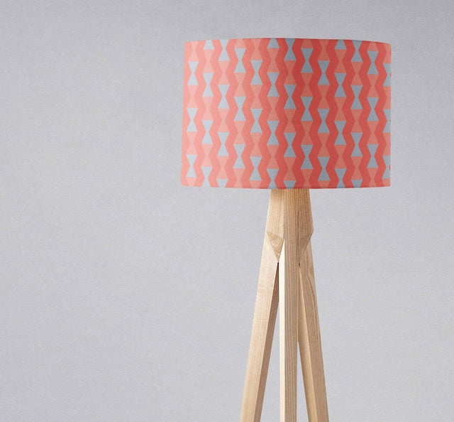Shadow Bright patterned lampshade in coral and blue on a wooden tripod floor lamp