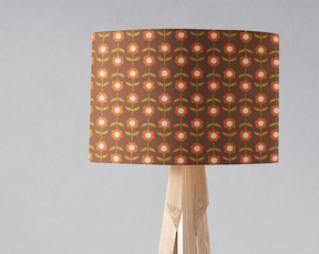 Vintage floral pattern lampshade in warm tones on a wooden lamp stand