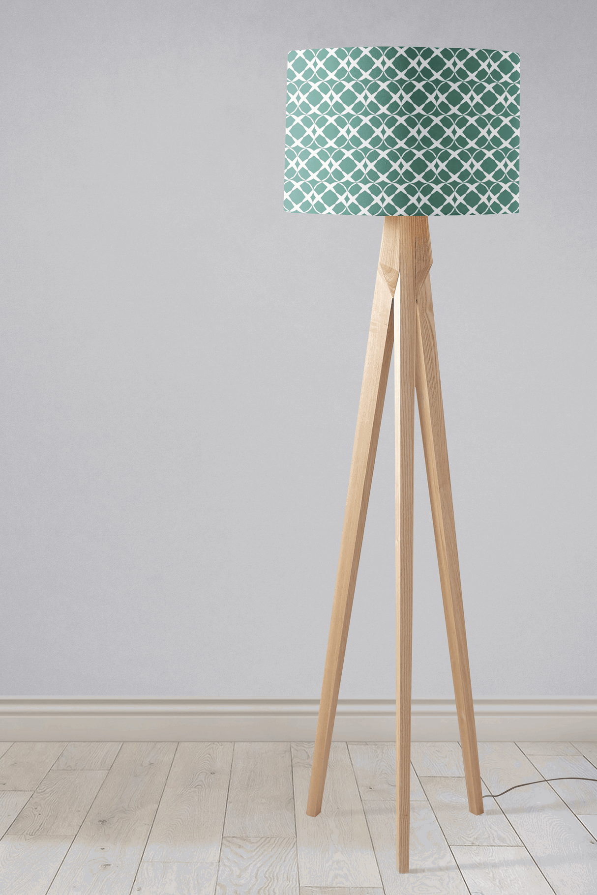 Shadow Bright Lampshade with a geometric pattern on a wooden tripod floor lamp