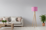 Modern pink patterned lampshade on a tripod floor lamp in a stylish living room setting