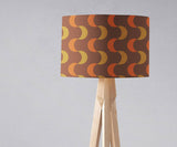 Shadow Bright lampshade with a retro pattern in orange and yellow on a wooden floor lamp