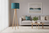 Stylish blue geometric lampshade on a wooden floor lamp in a modern living room setting