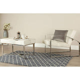 Orsina Lattice Rug featuring a geometric design, placed under a modern coffee table and chair