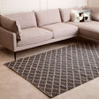 Orsina Lattice Rug in grey and white, placed under a stylish modern couch for a chic living room look