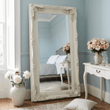 Elegant Leaner Mirror with Ornate White Frame in Stylish Bedroom Setting