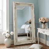 Elegant Leaner Mirror with Ornate White Frame in Stylish Bedroom Setting