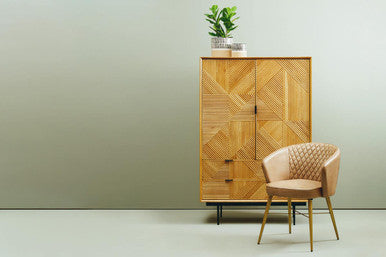 Stylish Orsina Leather Chair with a quilted design next to a wooden storage cabinet