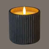Shades 4 Seasons LED Candle in a textured black holder, providing a warm and soothing glow