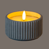Shades 4 Seasons LED Candle in a textured grey holder with a soft glowing flame