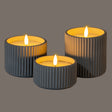 Set of three grey ribbed LED Candles with warm flickering light for a calming ambiance
