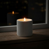 Shades 4 Seasons LED Candle in a textured white holder providing a warm glow for home decor
