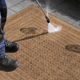Limonero Rug being cleaned with a pressure washer, showcasing its durable and water-resistant design