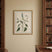 Framed Linen Artwork featuring botanical illustration in a warm library setting with bookshelves