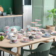 Elegant Afternoon Tea Set displayed on a table featuring floral teapots, cups, and tiered stands