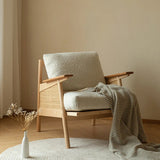 Nisu Home Lounge Chair with a soft cushion and natural wooden frame, perfect for stylish indoor spaces