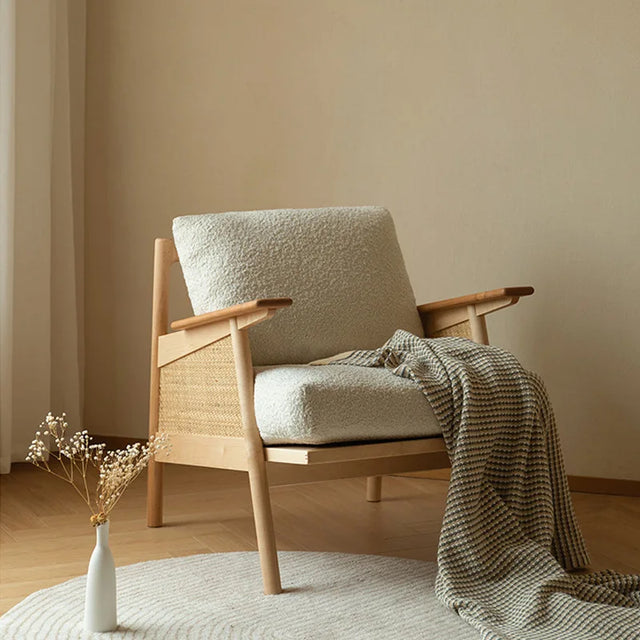 Nisu Home Lounge Chair with a soft cushion and natural wooden frame, perfect for stylish indoor spaces