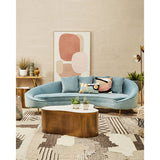 Contemporary wall art by Orsina displayed above a stylish blue sofa in a modern living room setting